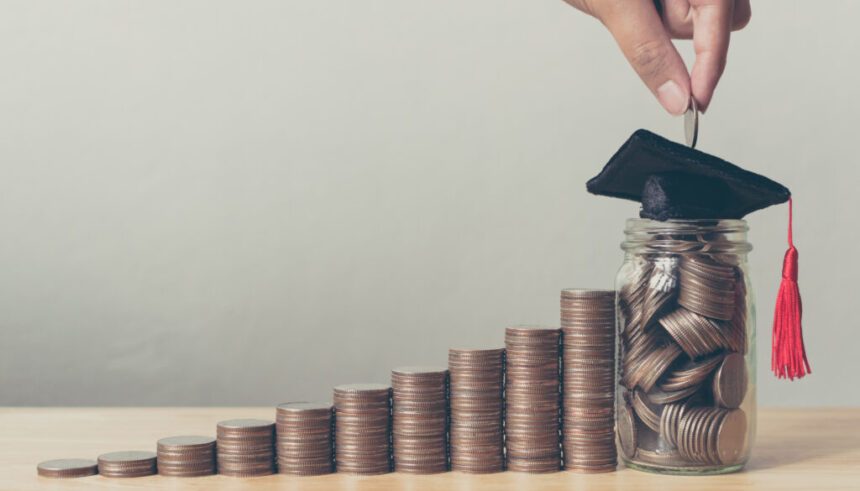 Scholarship money concept. Hand of male or female putting coins in jar with money stack step growing growth saving money investment